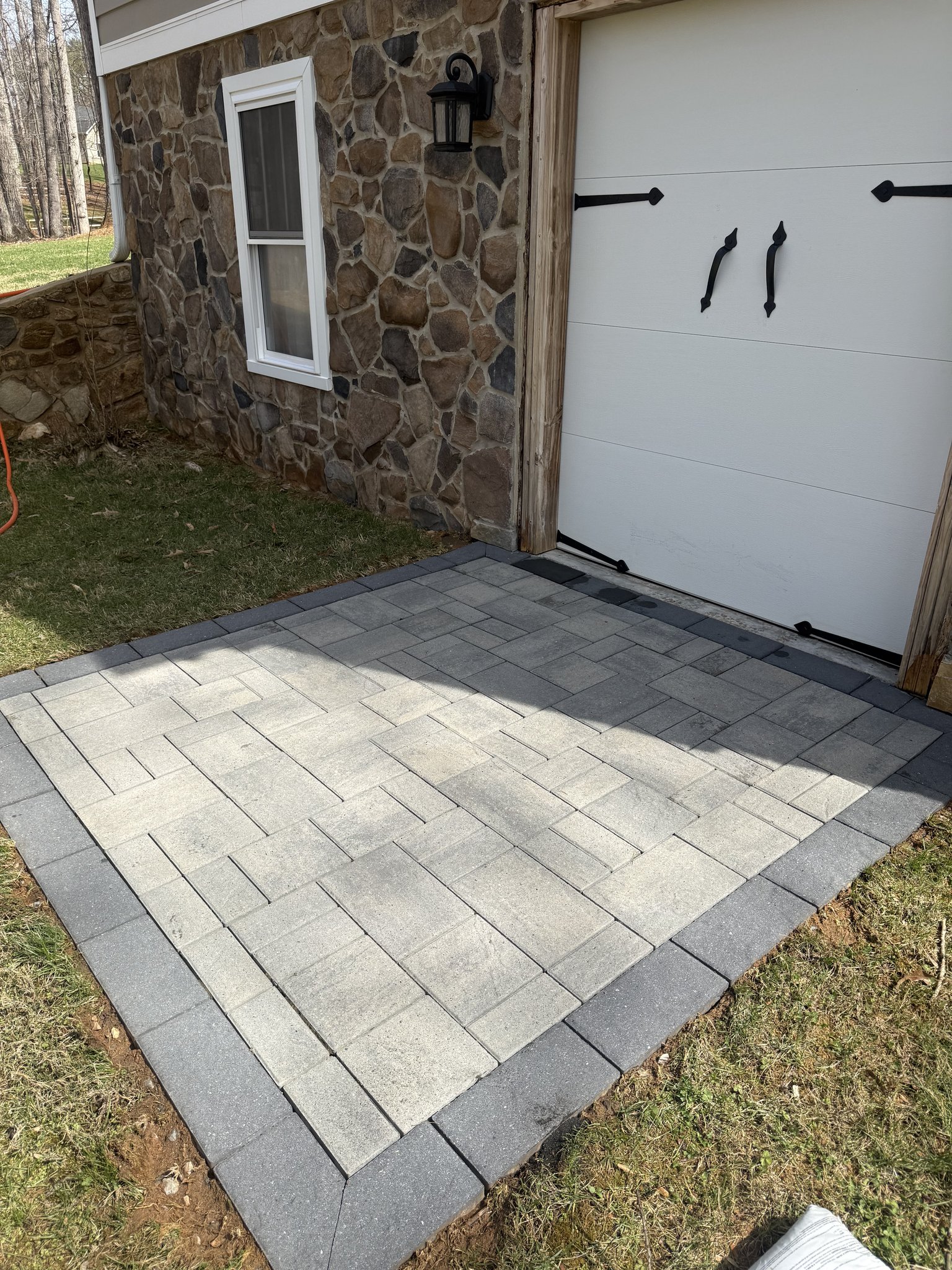 Freshly cleaned paver pad by the stone garage in Huddleston, VA