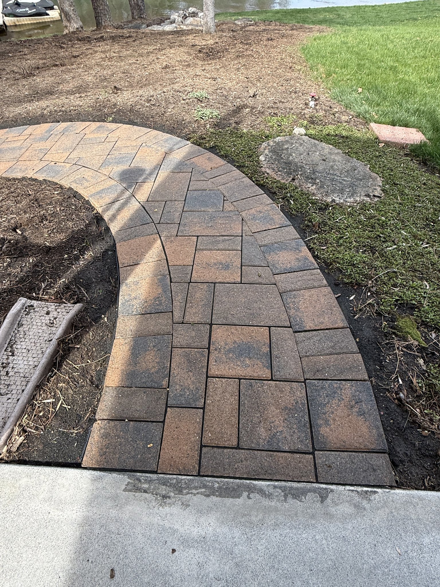 Curved back paver path after cleaning, sanding, and sealing