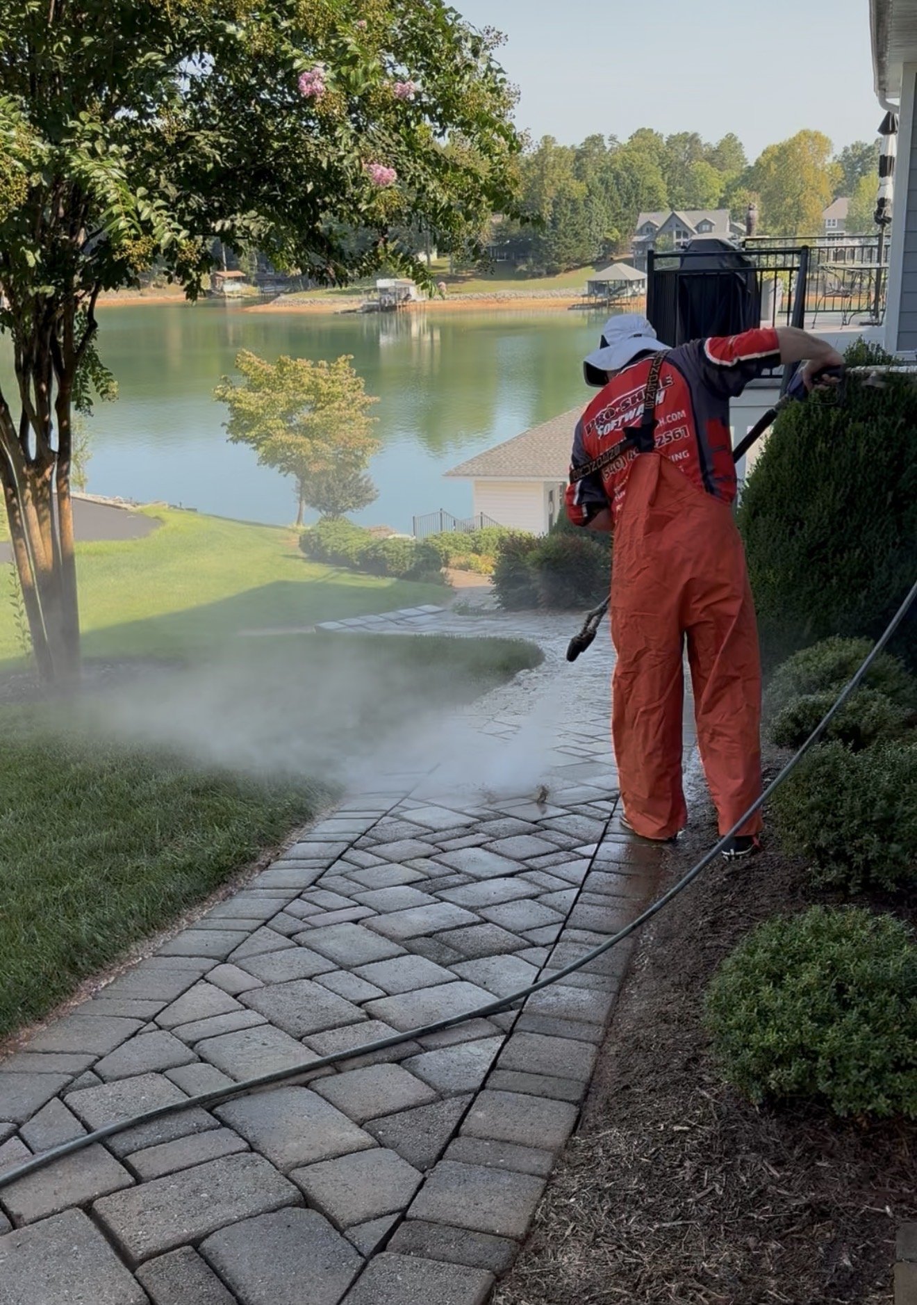 Pro-Shine Softwash deep cleaning the paver walkway and flushing the joints above the lake in Huddleston, VA