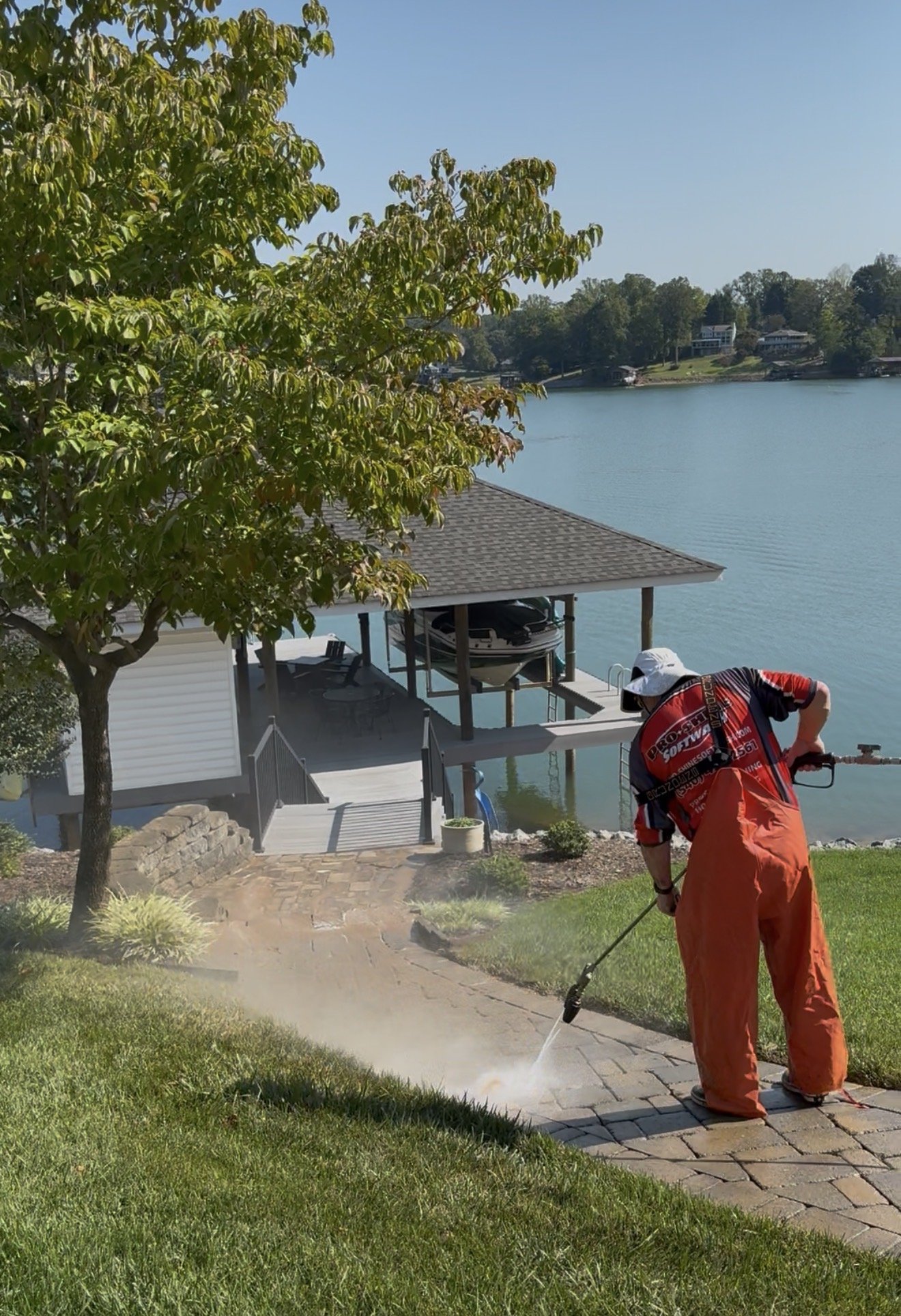 Clearing dirt and moss out of the joints on the lower run of the walkway at Smith Mountain Lake