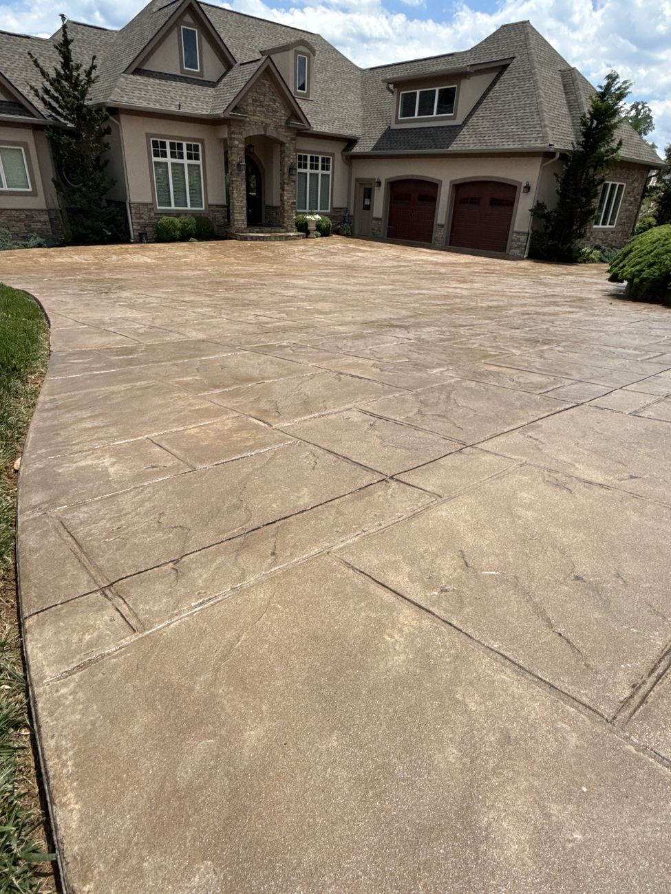 Sealed stamped concrete driveway with restored color in front of Moneta, VA home