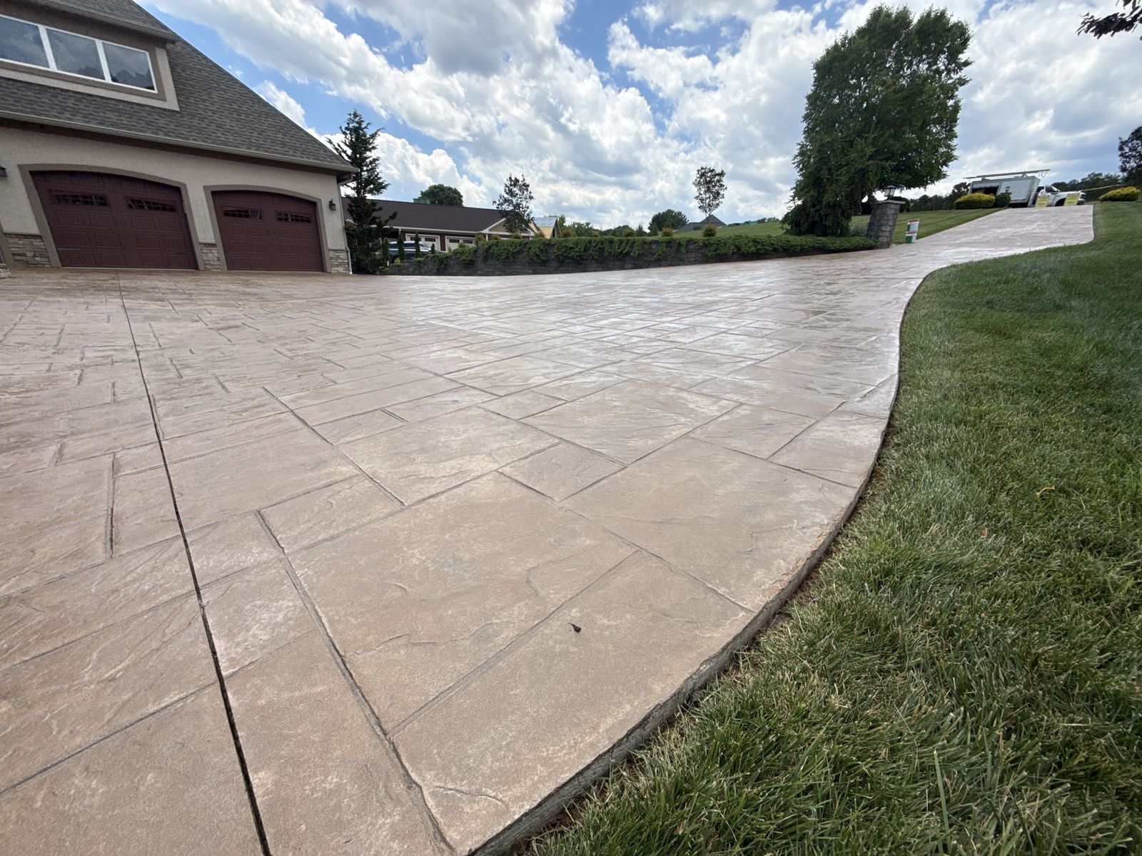 Finished stamped concrete driveway after cleaning and sealing in Moneta, VA — rich restored color
