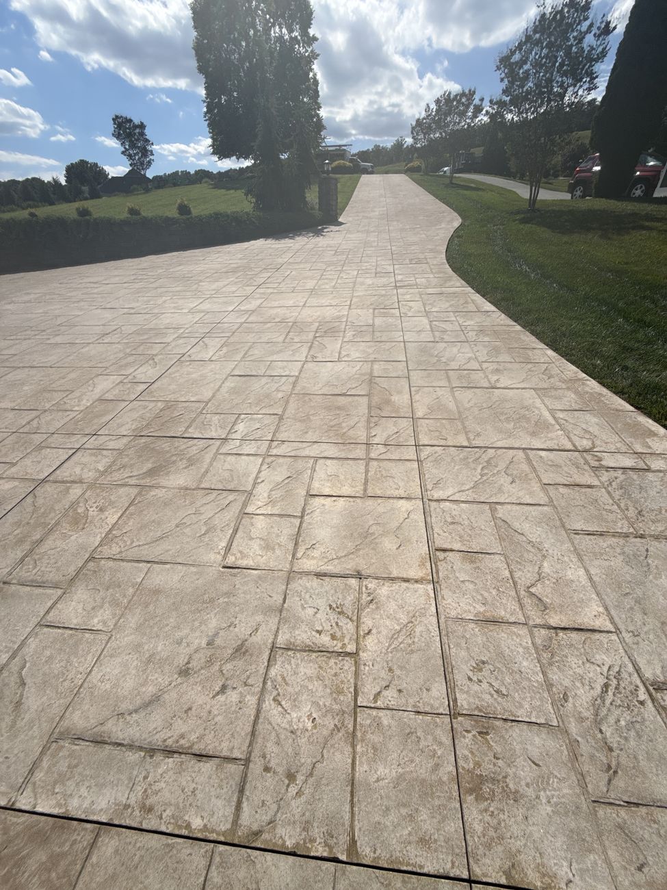 Long stamped concrete driveway fully cleaned before sealing in Moneta, VA